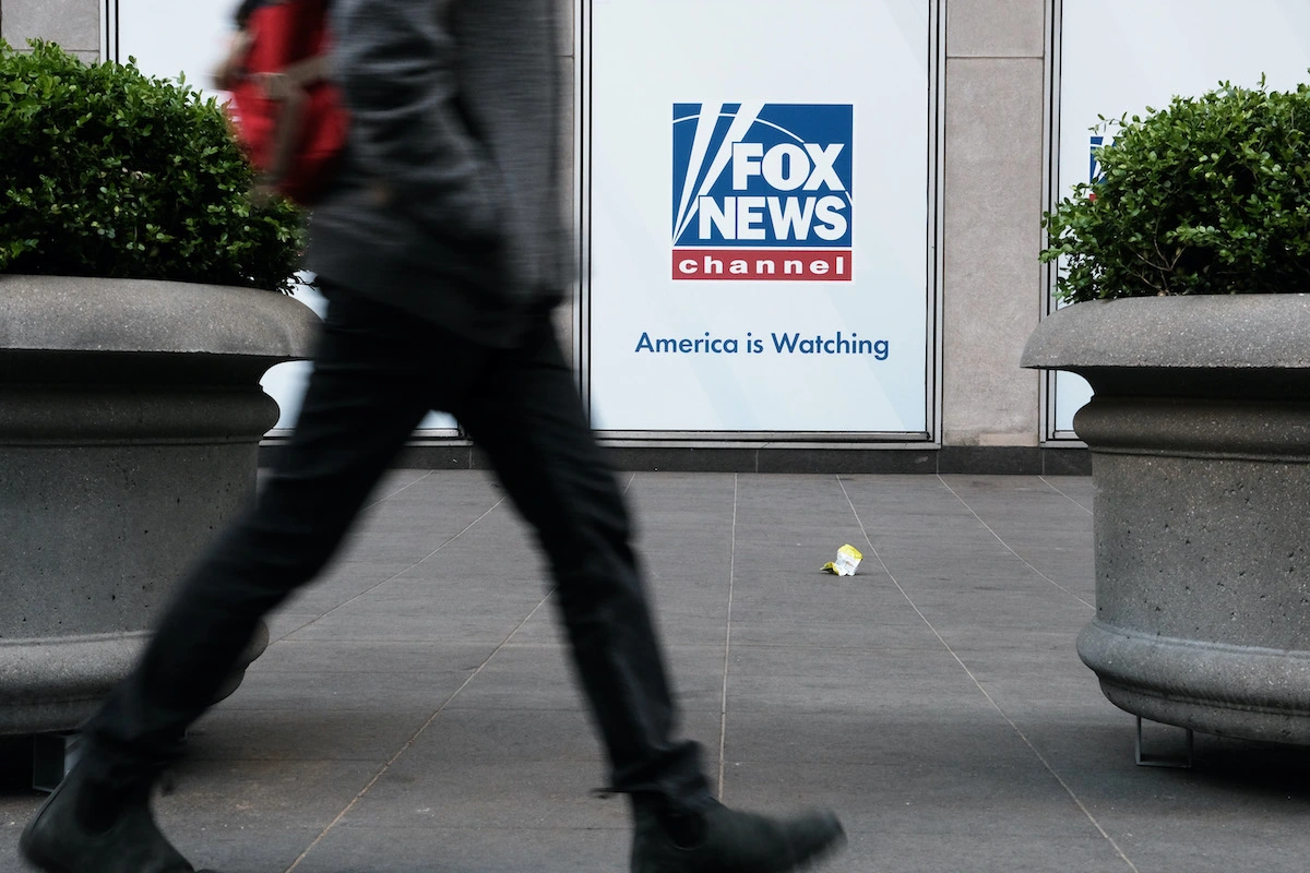 A Person Seen From The Waist Down Walks By The Fox News Office.